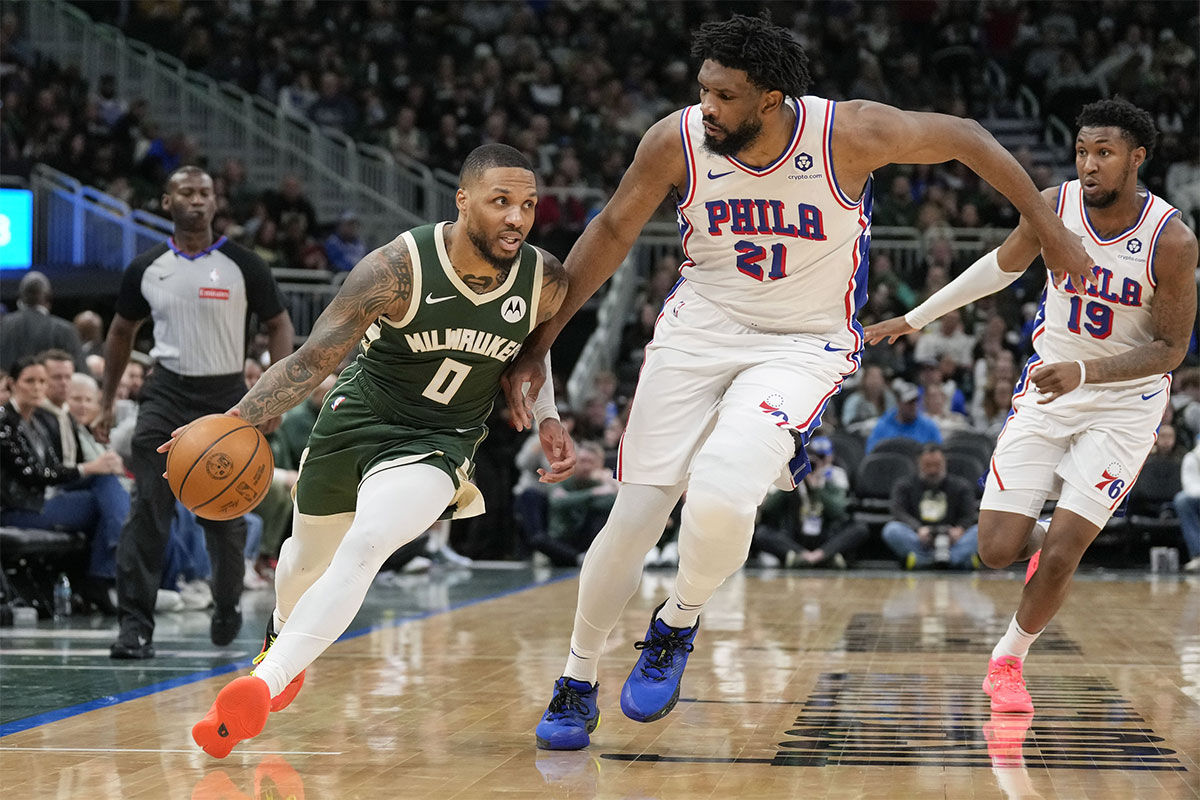 Milvaukee Bucks Guard Damian Lillard (0) Cart vehicles vs. Philadelphia 76ers Center Joel EmbiId (21) during the third quarter of Fiserv Forum.