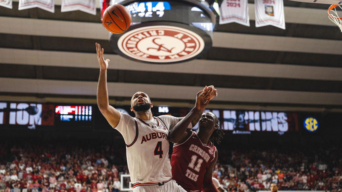 Feb 15, 2025; Tuscaloosa, Alabama, USA; Auburn Tigers forward Johni Broome (4) and Alabama Crimson Tide center Clifford Omoruyi (11) struggle over a rebound during the first half at Coleman Coliseum. Mandatory Credit: Will McLelland-Imagn Images
