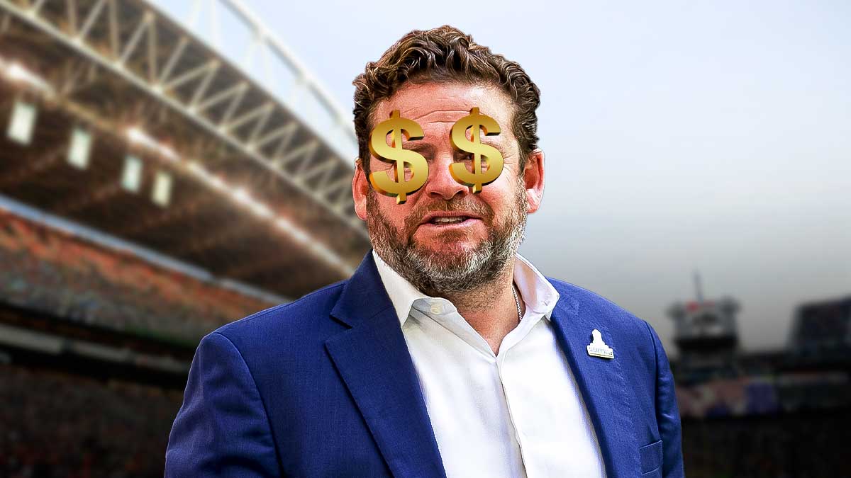 Seahawks general manager John Schneider with dollar signs in the background.