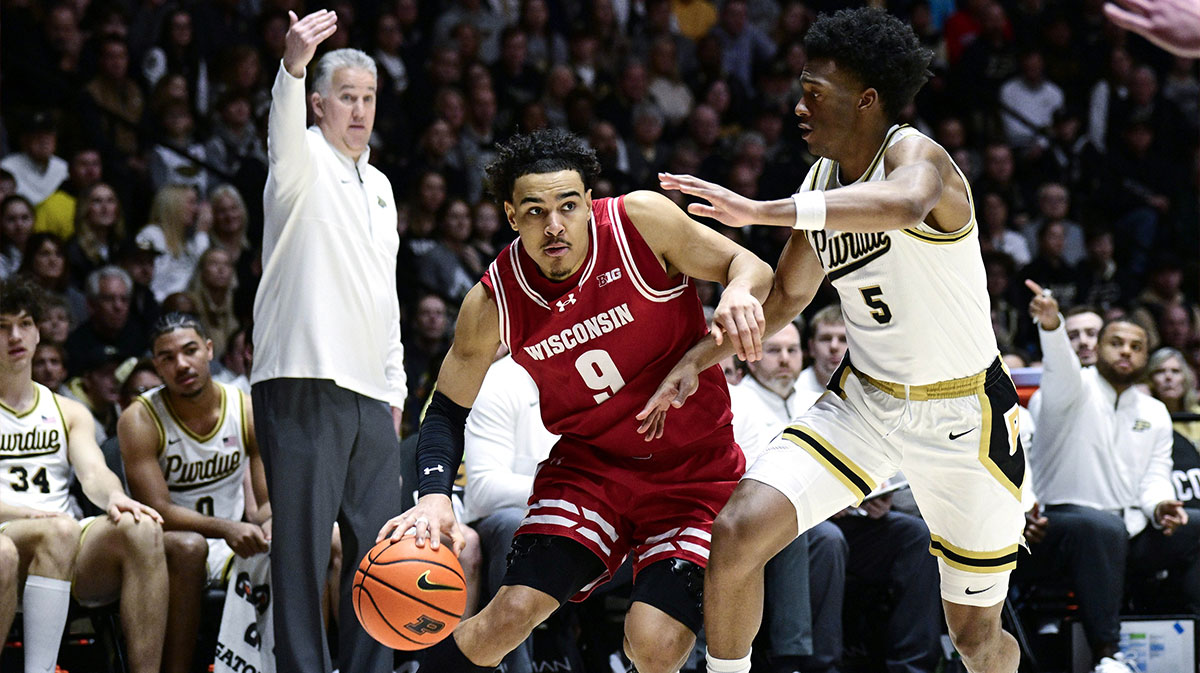 Wisconsin Badgers guard John Tonje (9) drives the ball around Purdue Boilermakers guard Myles Colvin (5) during the first half at Mackey Arena.