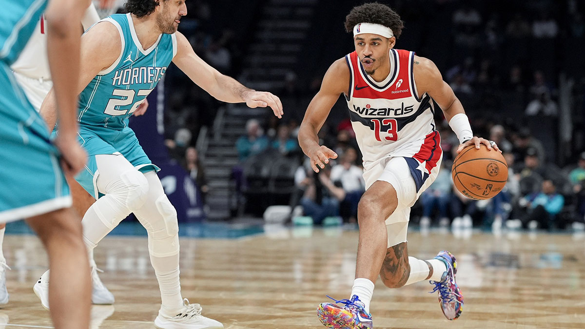 Washington Vizards Guard Jordan Poole (13) handles the ball against Charlotte Hornets Vasilij Mićić (22) during the second half in Spectrum Center