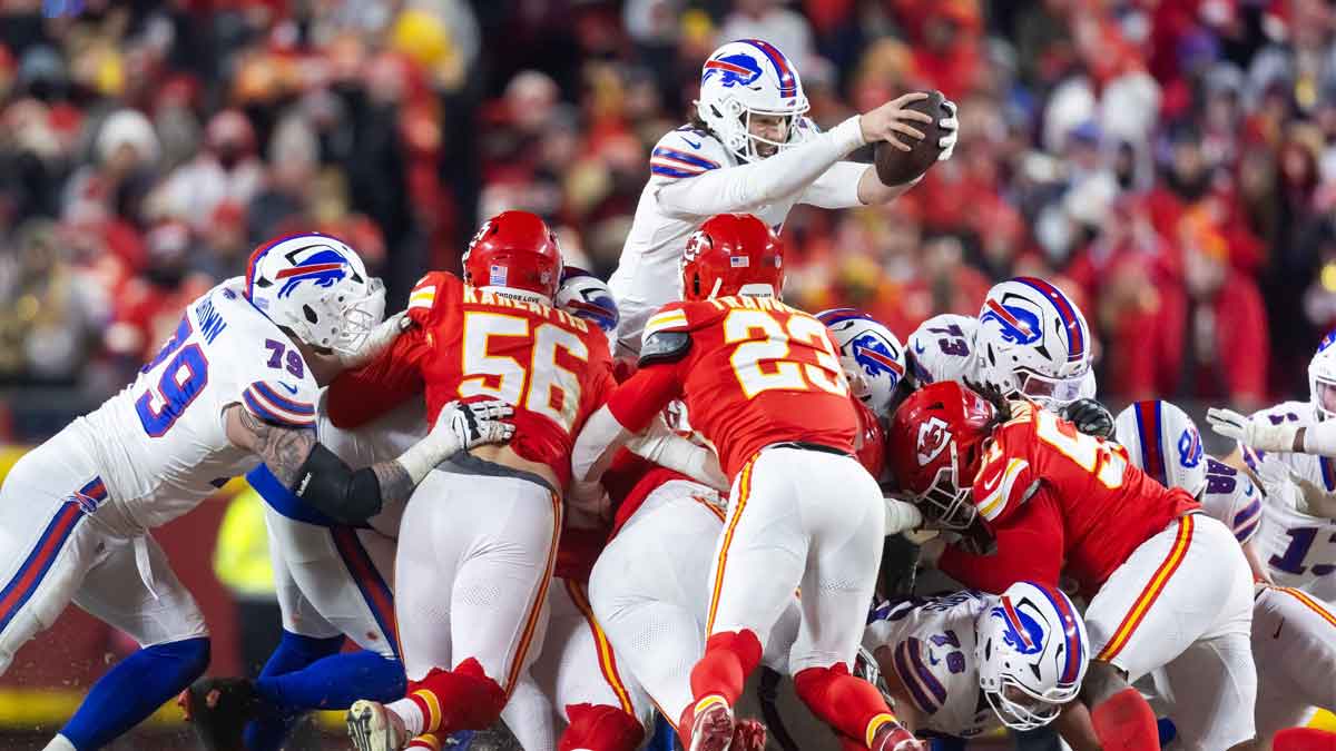 Jan 26, 2025; Kansas City, MO, USA; Buffalo Bills quarterback Josh Allen (17) leaps over the line of Kansas City Chiefs defenders during the AFC Championship game at GEHA Field at Arrowhead Stadium. 