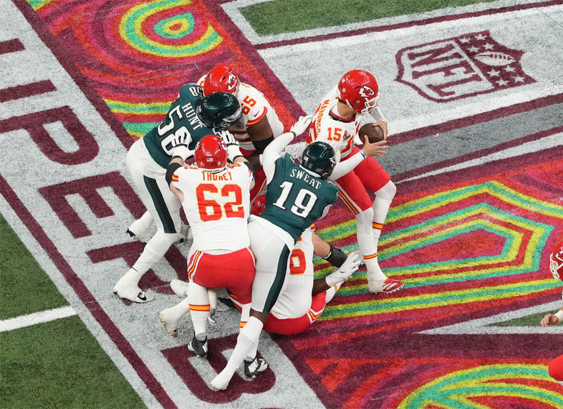 Feb 9, 2025; New Orleans, LA, USA; Kansas City Chiefs quarterback Patrick Mahomes (15) is pressured by Philadelphia Eagles linebacker Josh Sweat (19) in the second quarter during Super Bowl LIX at Caesars Superdome. 