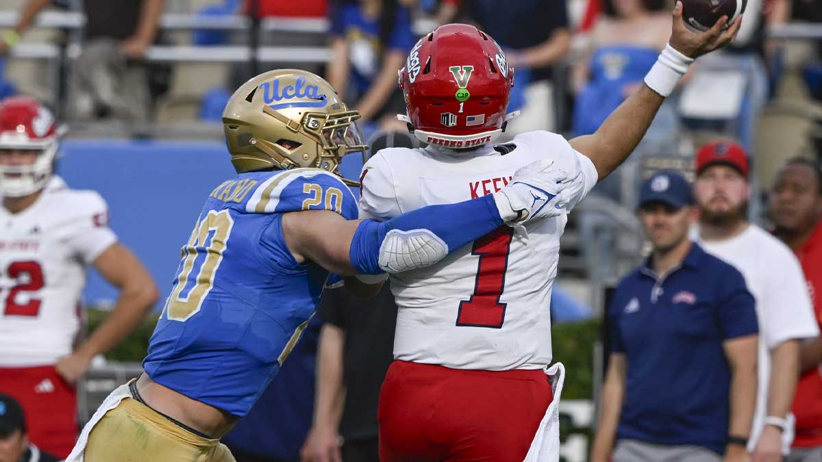 UCLA Bruins linebacker Kain Medrano (20) hits Fresno State Bulldogs quarterback Mikey Keene (1) as he throws a pass during the second quarter at Rose Bowl. Mandatory Credit: Robert Hanashiro-Imagn Images