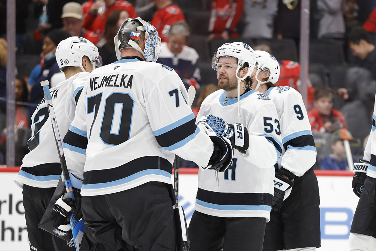 Utah Hockey Club goaltender Karel Vejmelka (70) celebrates with teammates after defeating the Washington Capitals during the third period at Capital One Arena.