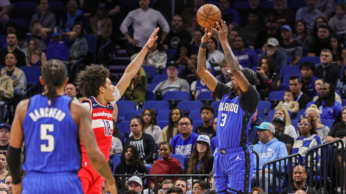 Feb 23, 2025; Orlando, Florida, USA; Orlando Magic guard Kentavious Caldwell-Pope (3) shoots over Washington Wizards forward Kyshawn George (18) during the first quarter at Kia Center.