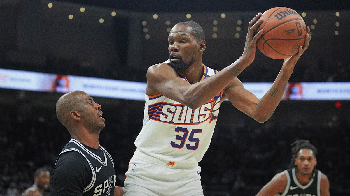 Phoenix Suns forward Kevin Durant (35) looks to drive to the basket while defended by San Antonio Spurs guard Chris Paul (3) during the first half at Moody Center.