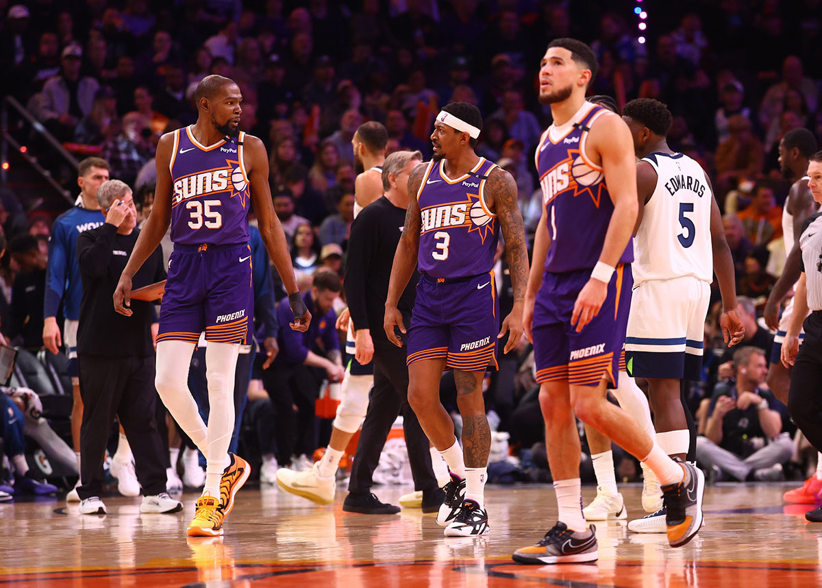 Phoenix Suns forward Kevin Durant (35) with guard Bradley Beal (3) and Devin Booker (1) against the Minnesota Timberwolves at Footprint Center.