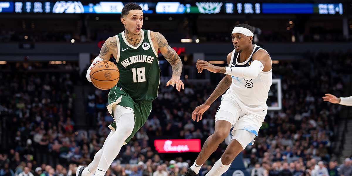 Milwaukee Bucks forward Kyle Kuzma (18) dribbles against Minnesota Timberwolves forward Jaden McDaniels (3) in the fourth quarter at Target Center