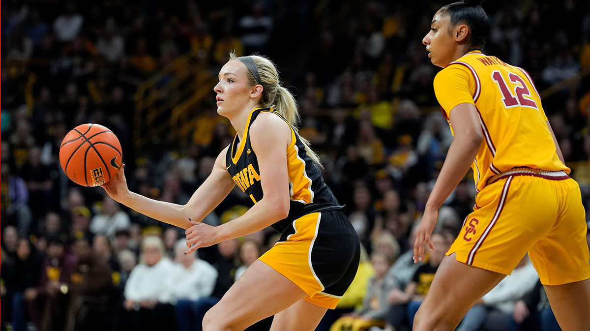 Iowa Hawkeyes guard Kylie Feuerbach (4) looks to pass as USC Trojans guard JuJu Watkins (12) defends during a Big Ten women’s basketball game Sunday, Feb. 2, 2025 at Carver-Hawkeye Arena in Iowa City, Iowa.