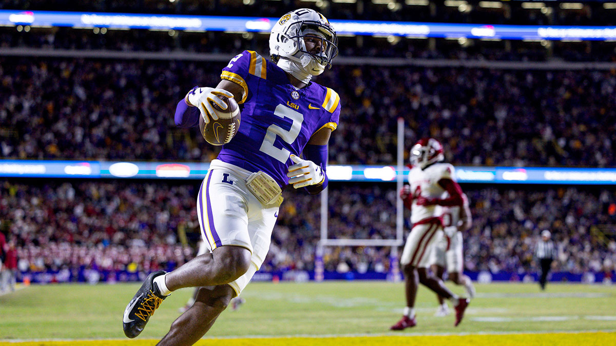 LSU Tigers wide receiver Kyren Lacy (2) runs after a catch and scores a touchdown against Oklahoma Sooners defensive back Billy Bowman Jr. (2) during the first quarter at Tiger Stadium.