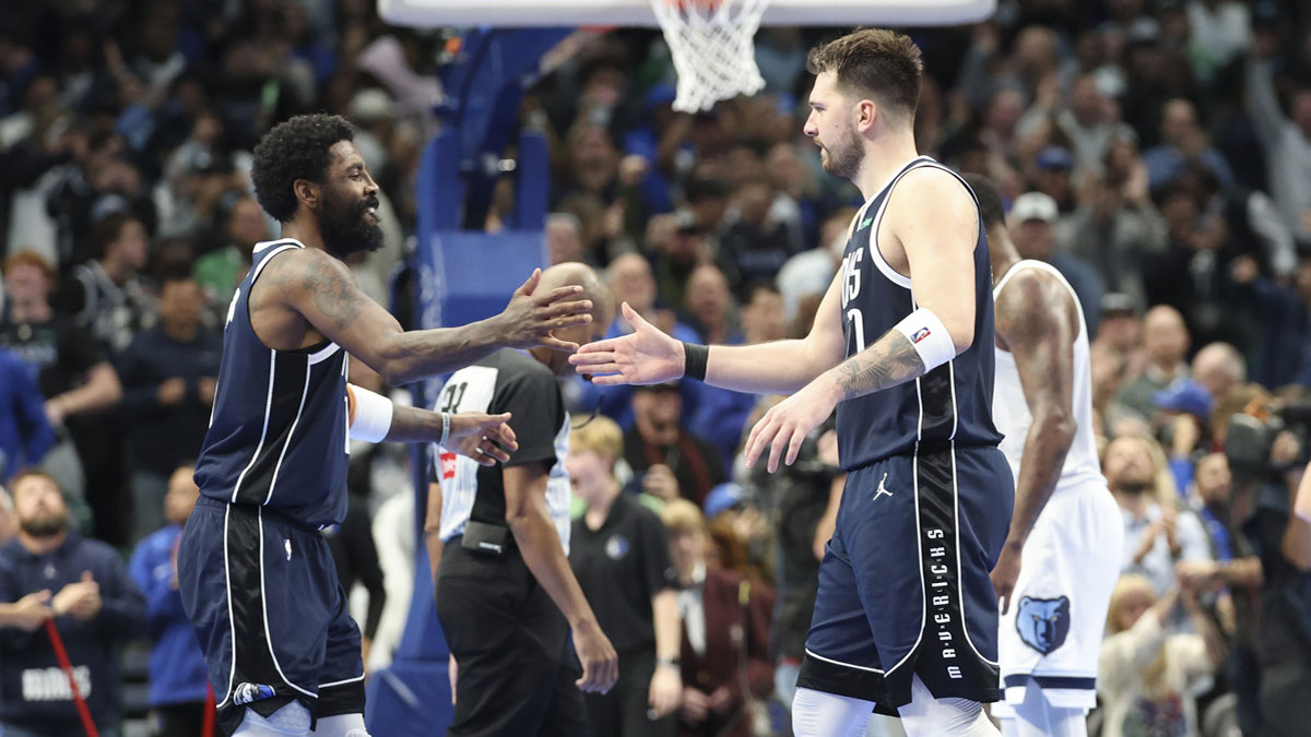 Dallas Mavericks guard Kyrie Irving (11) celebrates with Dallas Mavericks guard Luka Doncic (77) during the fourth quarter against the Memphis Grizzlies at American Airlines Center.
