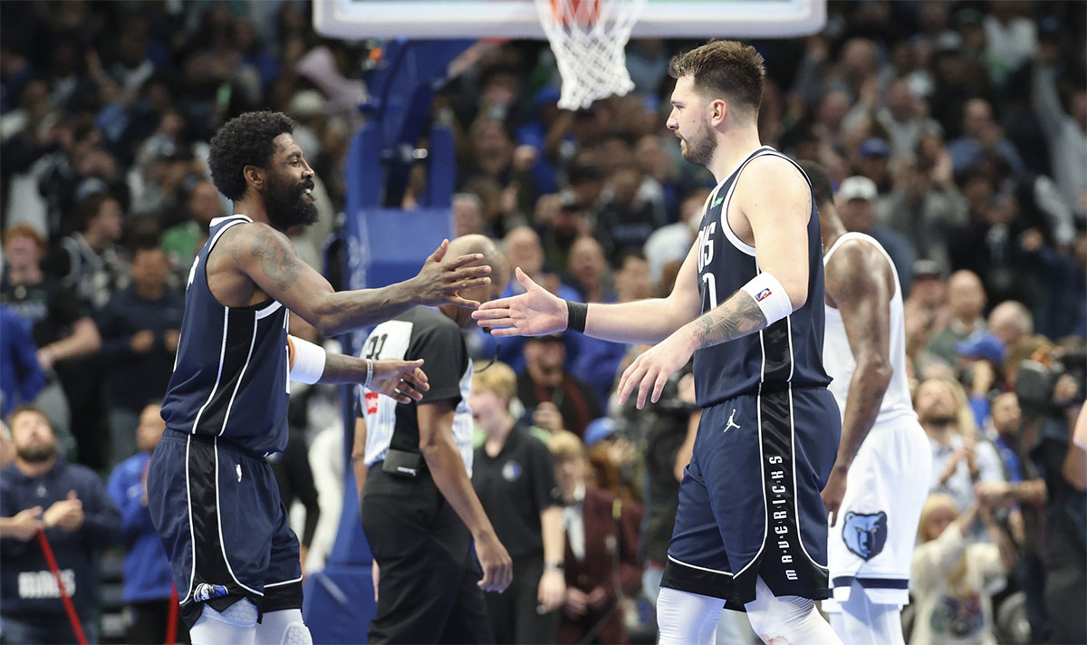 Dallas Mavericks guard Kyrie Irving (11) celebrates with Dallas Mavericks guard Luka Doncic (77) during the fourth quarter against the Memphis Grizzlies at American Airlines Center. 