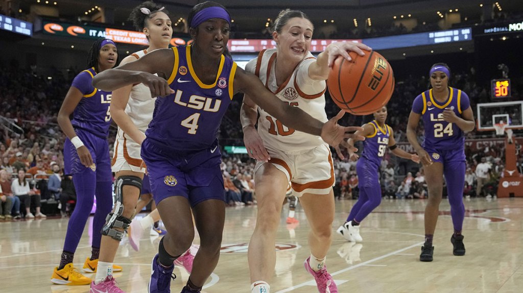 Louisiana State Lady Tigers guard Flau'jae Johnson (4) and Texas Longhorns guard Shay Holle (10) battle for the loose ball during the first half.