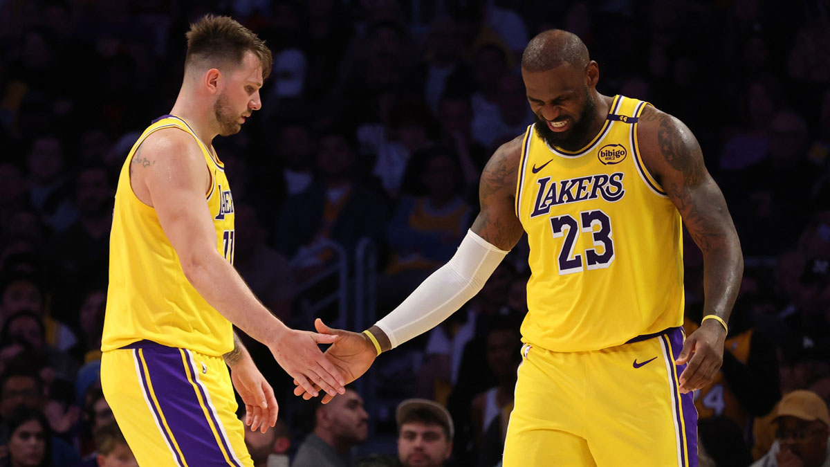 Lakers guard Luka Doncic (77) and forward LeBron James (23) celebrate after a play during the fourth quarter against the Minnesota Timberwolves at Crypto.com Arena