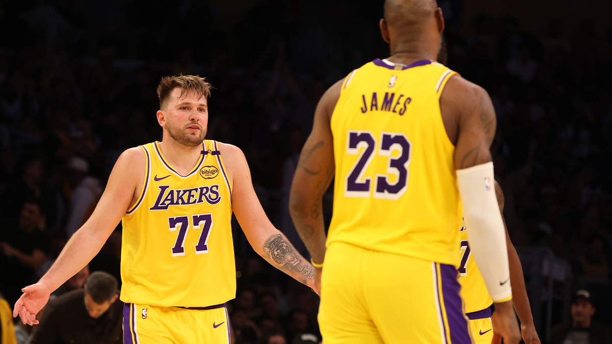 Lakers guard Luka Doncic (77) celebrates with forward LeBron James (23) after making a basket during the fourth quarter against the Minnesota Timberwolves at Crypto.com Arena