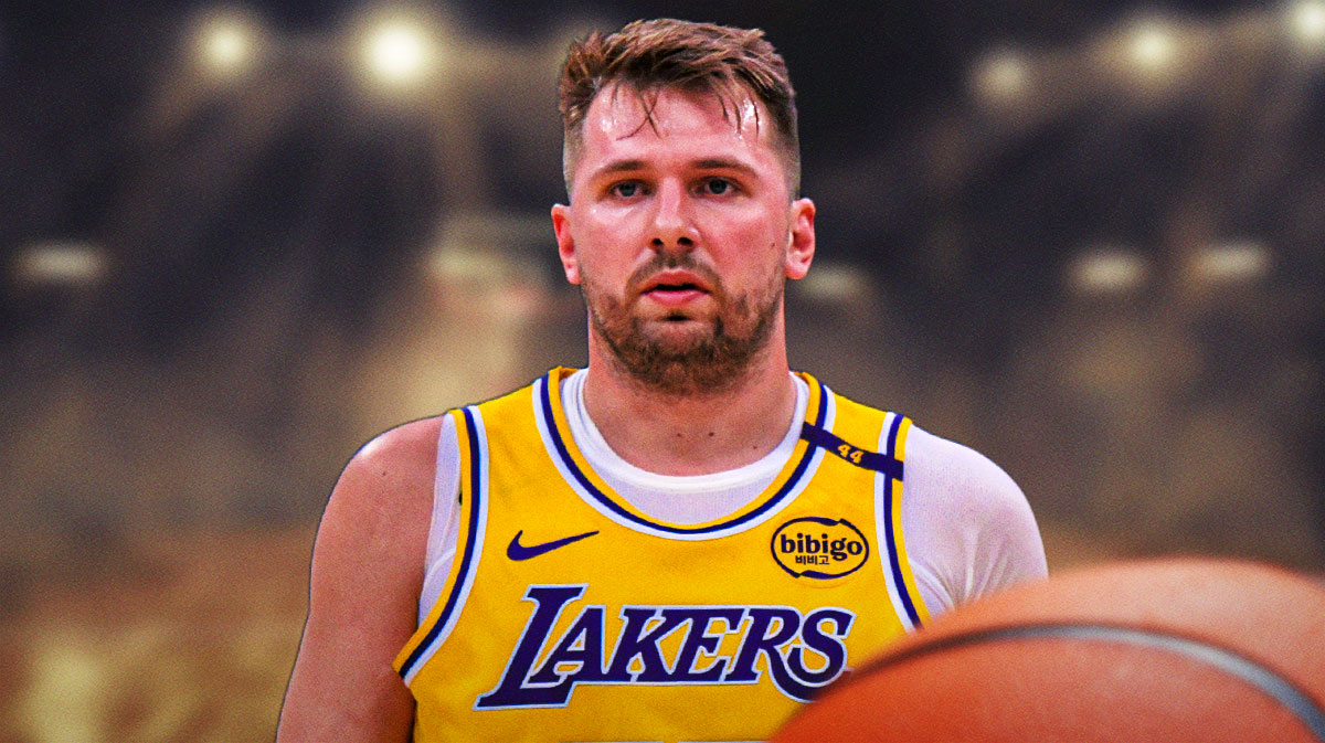 Luka Doncic in a Lakers uniform. Lakers fans in the background.