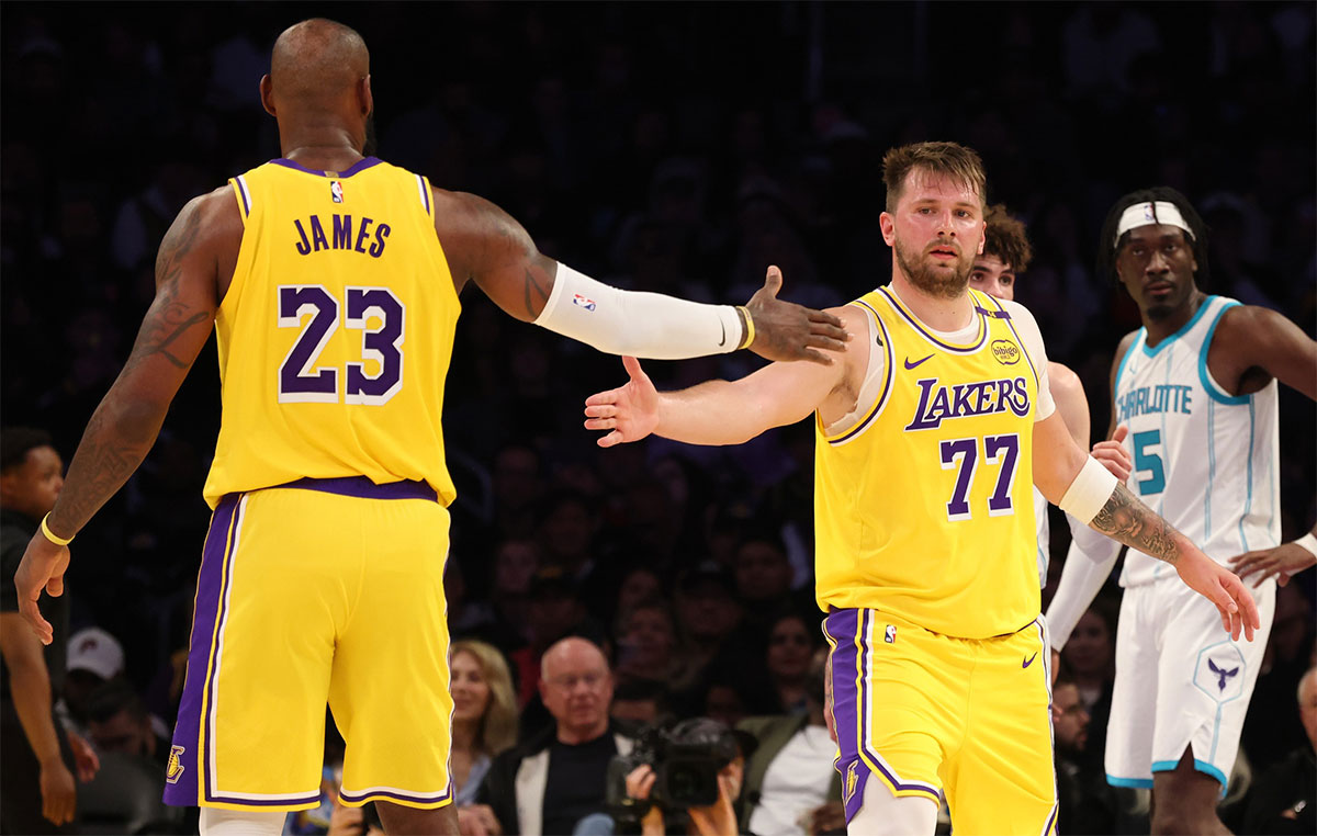 Lakers forward Lebron James (23) and Guard Luka Doncic (77) are celebrated after the game during the third quarter against Charlotte Hornets at Cripto.com Arena