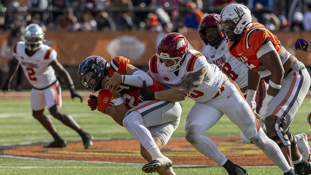 National team defensive lineman Landon Jackson of Arkansas (40) hits American team quarterback Jaxson Dart of Ole Miss (2) during the first half of the 2025 Senior Bowl football game at Hancock Whitney Stadium. Mandatory Credit: Vasha Hunt-Imagn Images