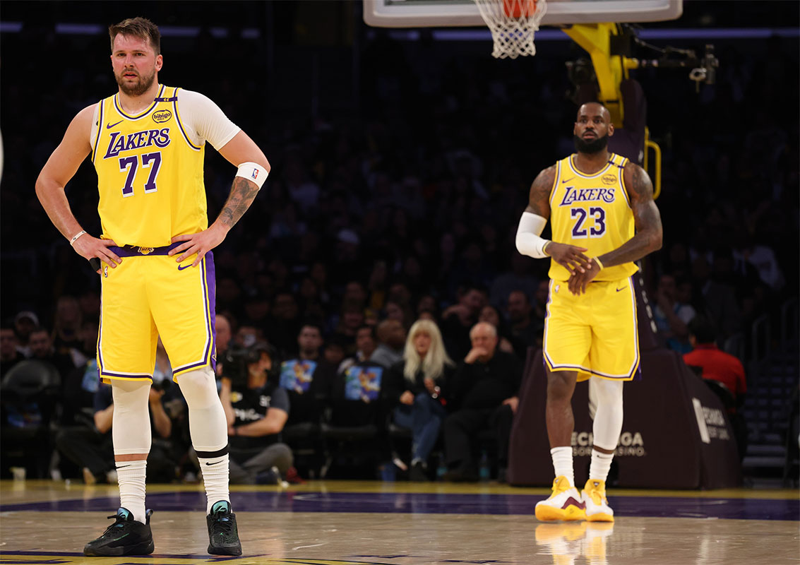 Los Angeles Lakers forward LeBron James (23) and guard Luka Doncic (77) during the first quarter against the Charlotte Hornets at Crypto.com Arena. 