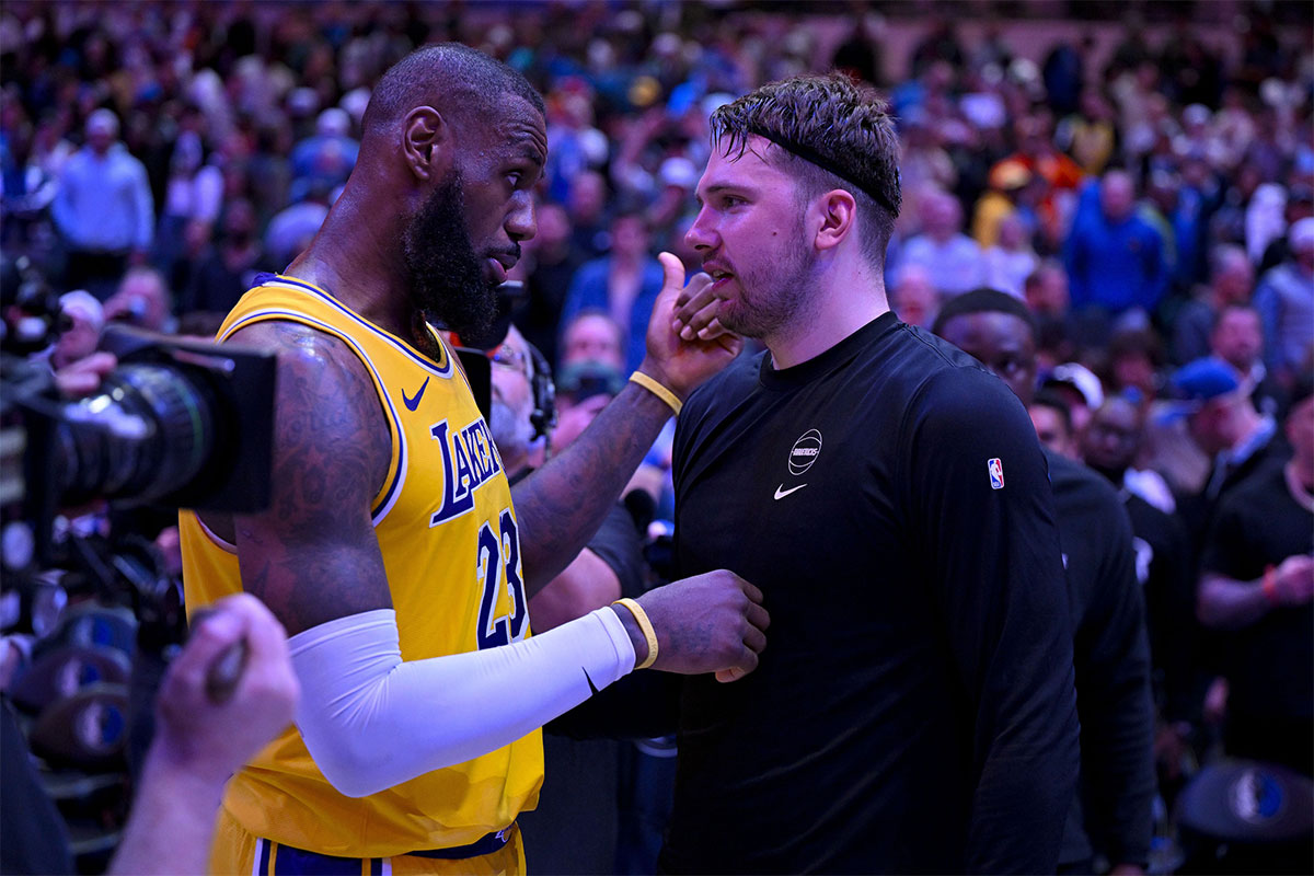 Los Angeles Lakers forward LeBron James (23) talks with Dallas Mavericks guard Luka Doncic (77) after the Mavericks defeat the Lakes at the American Airlines Center.