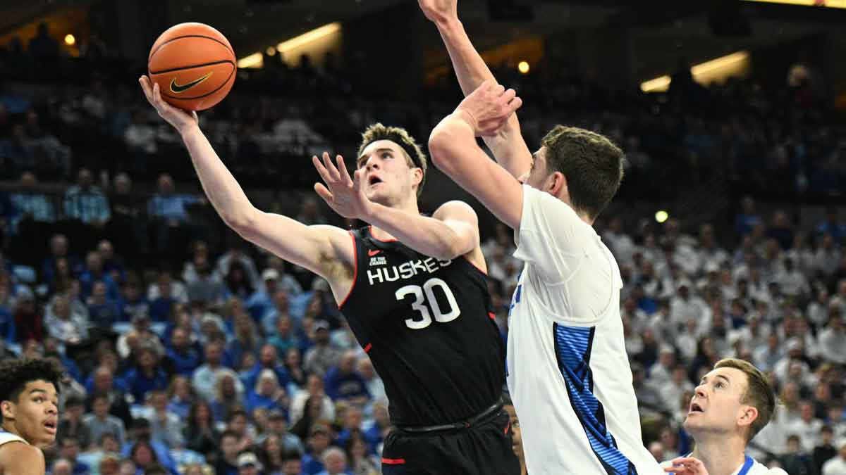 Connecticut Huskies forward Liam McNeeley (30) drives against Creighton Bluejays center Ryan Kalkbrenner (11) during the first half at CHI Health Center Omaha.