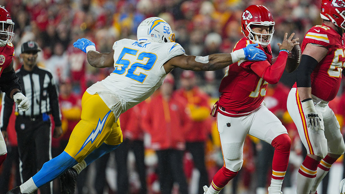 Kansas City Chiefs quarterback Patrick Mahomes (15) scrambles against Los Angeles Chargers linebacker Khalil Mack (52) during the first half at GEHA Field at Arrowhead Stadium.