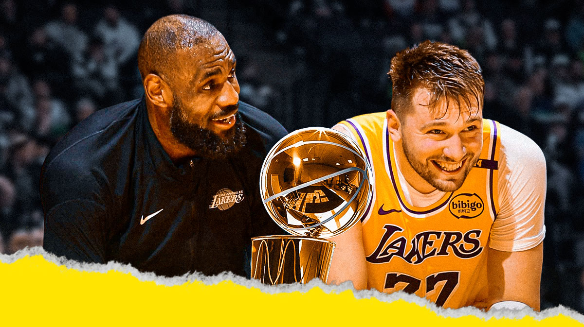 Lakers' Luka Doncic and LeBron James smiling together with the Larry O'Brien trophy beside them