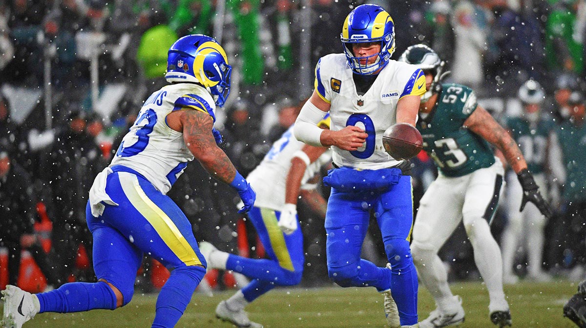 Los Angeles Rams quarterback Matthew Stafford (9) hands the ball off to running back Kyren Williams (23) against the Philadelphia Eagles in a 2025 NFC divisional round game at Lincoln Financial Field.