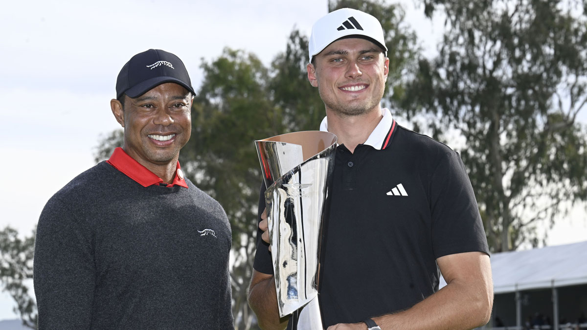  Ludvig Aberg holds the trophy next to Tiger Woods after winning The Genesis Invitational golf tournament at Torrey Pines