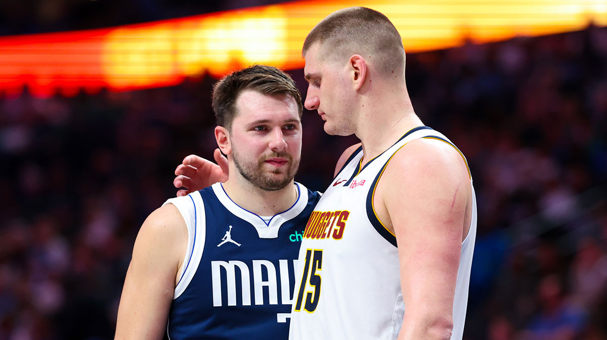 Dallas Mavericks Guard Luka Doncic (77) speaks to Denver Nuggets Center Nikola Jokić (15) during the second half in the center of American Airlines.