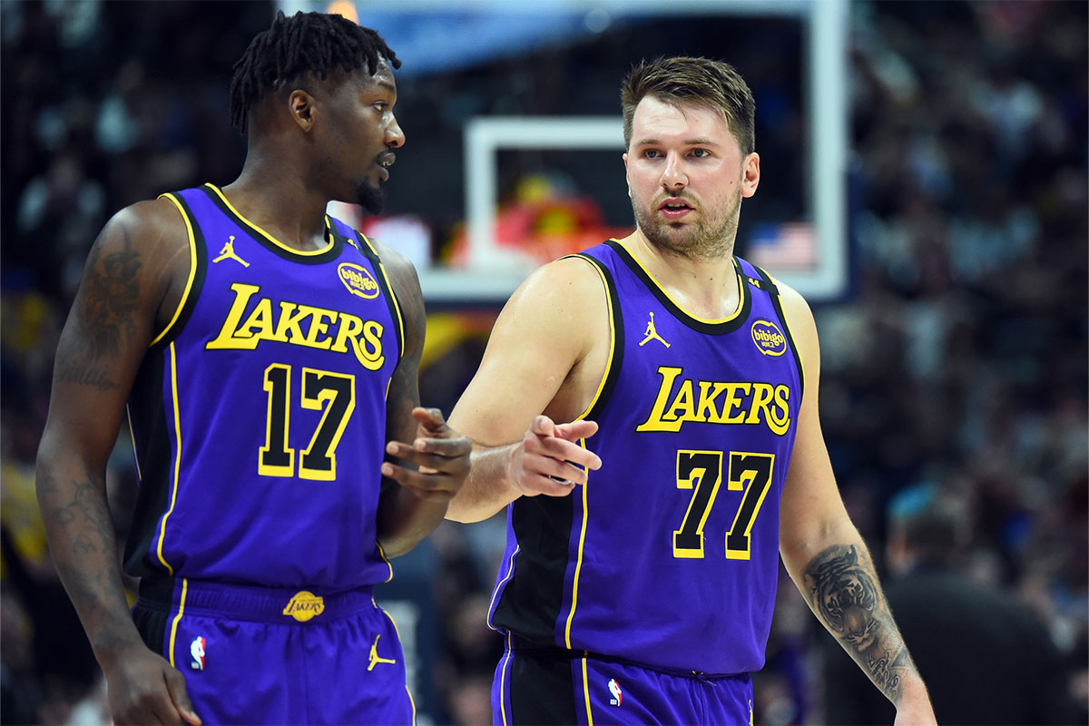 Los Angeles Lakers guard Luka Doncic (77) talks with forward Dorian Finney-Smith (17) during the second half against the Denver Nuggets at Ball Arena.