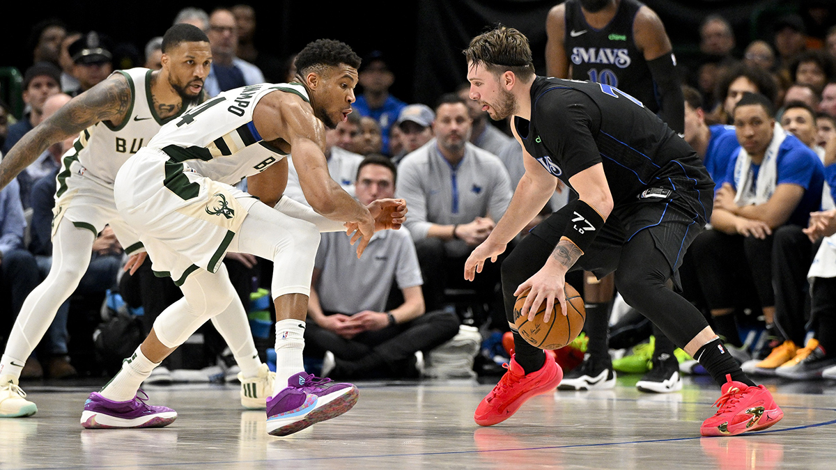 February 3, 2024; Dallas, Texas, United States; The Dallas Mavericks goalkeeper, Luka Doncic (77), is looking to move the ball after the Milwaukee Bucks Damian Lillard (0) goalkeeper and the striker of Giannis Antetokounmpo (34) during the second half at the American Airlines Center . Compulsory credit: Jerome Miron-Imagn images