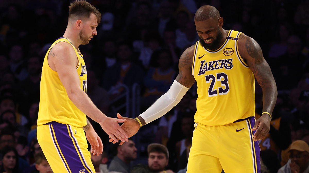 Los Angeles Lakers guard Luka Doncic (77) and forward LeBron James (23) celebrate after a play during the fourth quarter against the Minnesota Timberwolves at Crypto.com Arena.