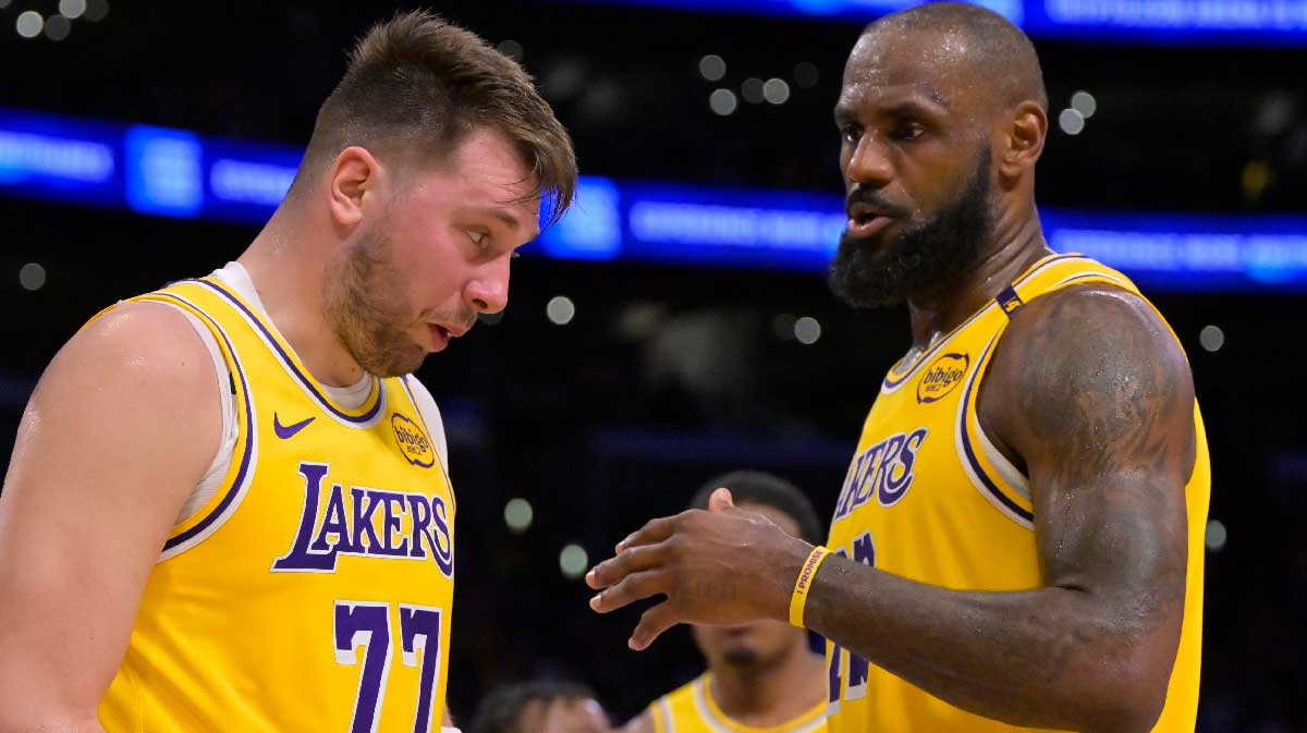  Los Angeles Lakers forward LeBron James (23) checks on guard Luka Doncic (77) after he was hit in the face against the Utah Jazz at Crypto.com Arena. 