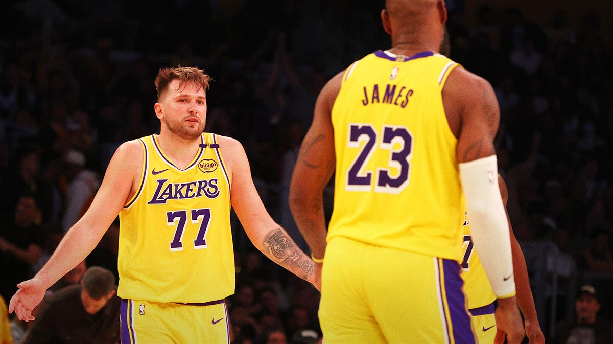 Los Angeles Lakers guard Luka Doncic (77) celebrates with forward LeBron James (23) after making a basket during the fourth quarter against the Minnesota Timberwolves at Crypto.com Arena.