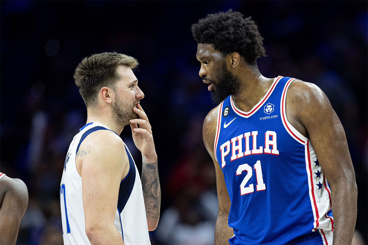 Philadelphia 76ers Center Joel EmdiId (21) Talks with Dallas Mavericks Guard Luka Doncic (77) During the fourth quarter in Wells Fargo Center. 