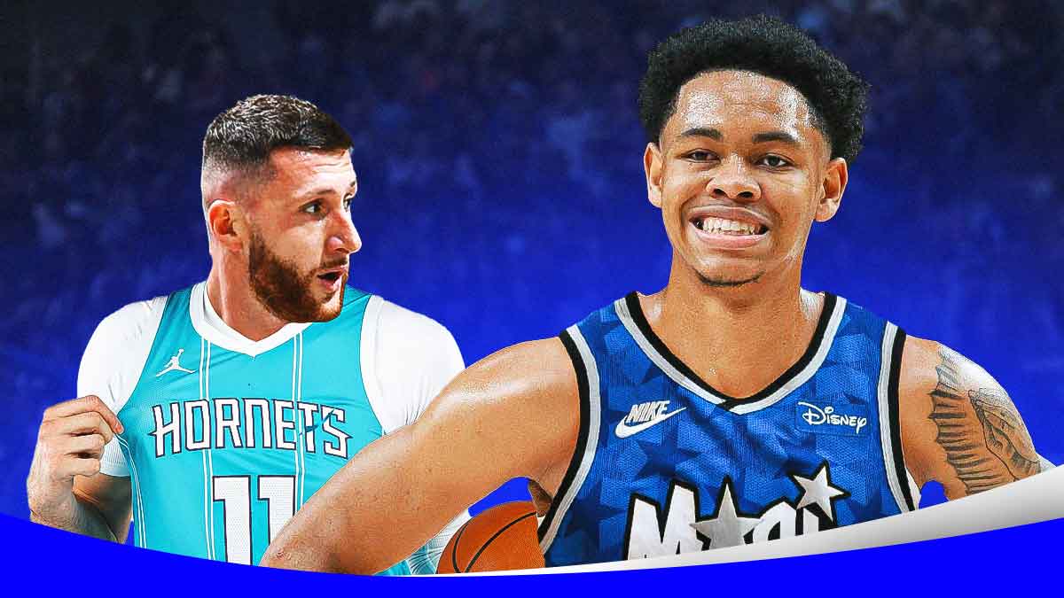 Hornets' Jusuf Nurkic looking at Blazers' Anfernee Simons in Magic uniform