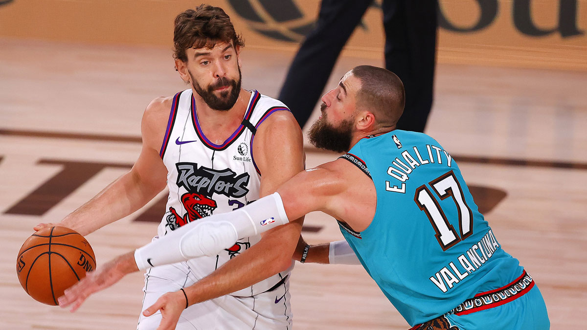 USA; Jonas Valanciunas #17 of the Memphis Grizzlies defends Marc Gasol #33 of the Toronto Raptors at Visa Athletic Center at ESPN Wide World Of Sports Complex.