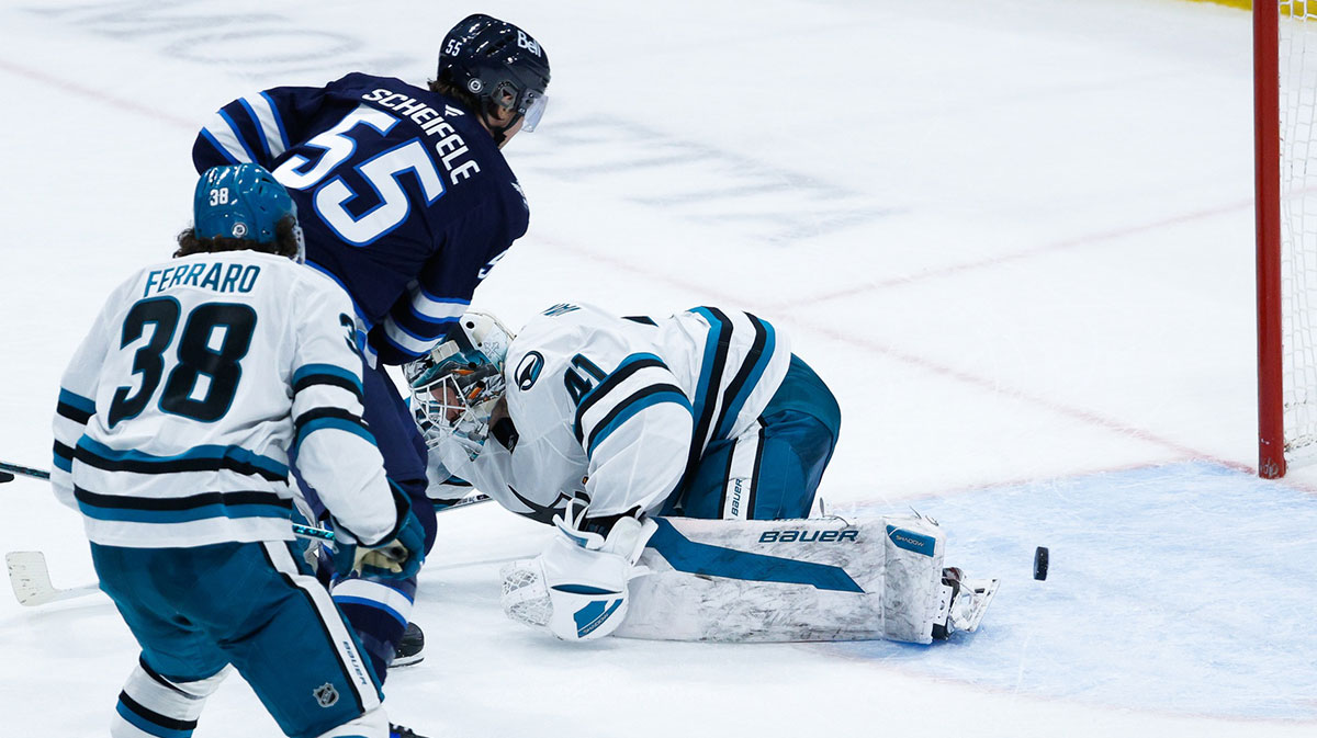 Winnipeg Jets forward Mark Scheifele (55) scores on San Jose Sharks goalie Vitek Vanecek (41) during the overtime period at Canada Life Centre.