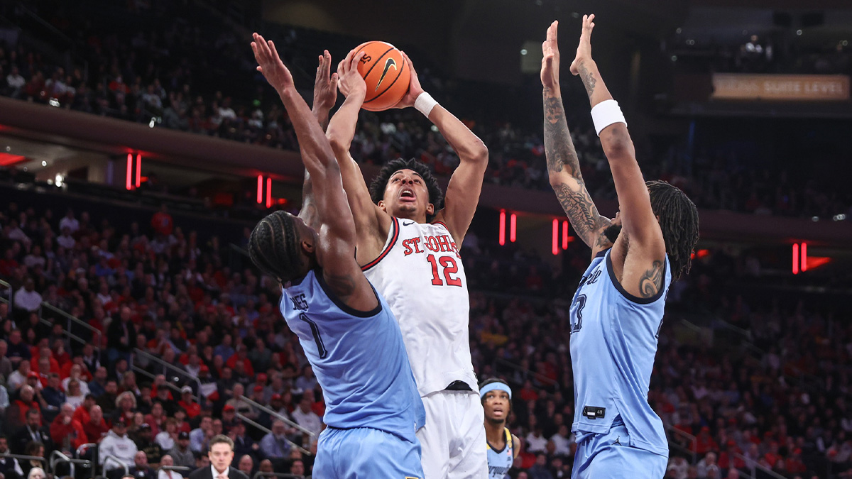 St. John's Red Storm guard RJ Luis Jr. (12) looks to post up against Marquette Golden Eagles guard Kam Jones (1) in the second half at Madison Square Garden.