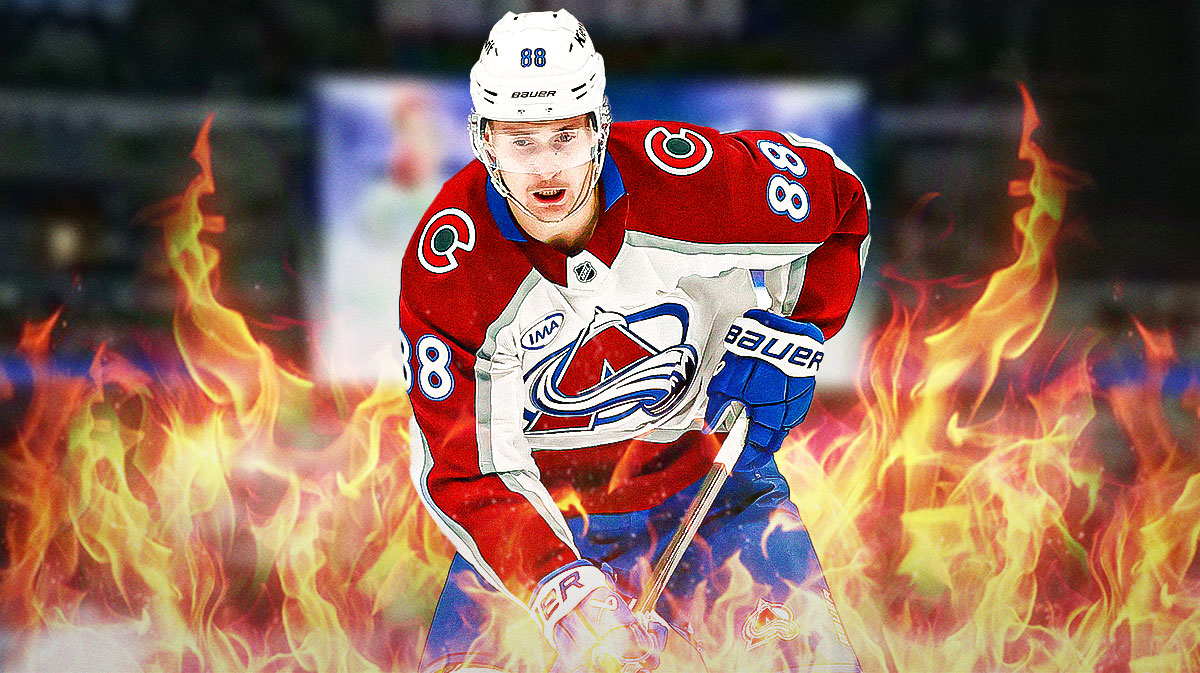 Martin Necas with fire around him looking happy, Ball Arena in background Colorado Avalanche