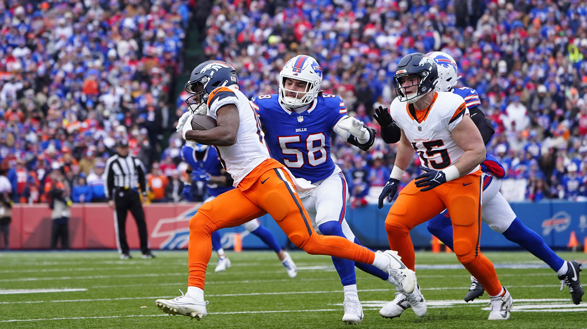 Denver Broncos wide receiver Marvin Mims Jr. (19) runs for a gain as Buffalo Bills linebacker Matt Milano (58) defends during the second quarter in an AFC wild card game at Highmark Stadium.