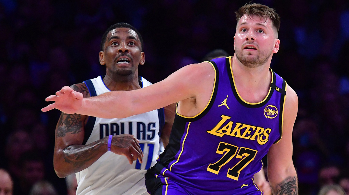 Los Angeles Lakers Guard Luka Doncic (77) and Dallas Mavericks Guard Kirie Irving (11) try to get control during the first quarter at the CRIPTO.com Arena. 