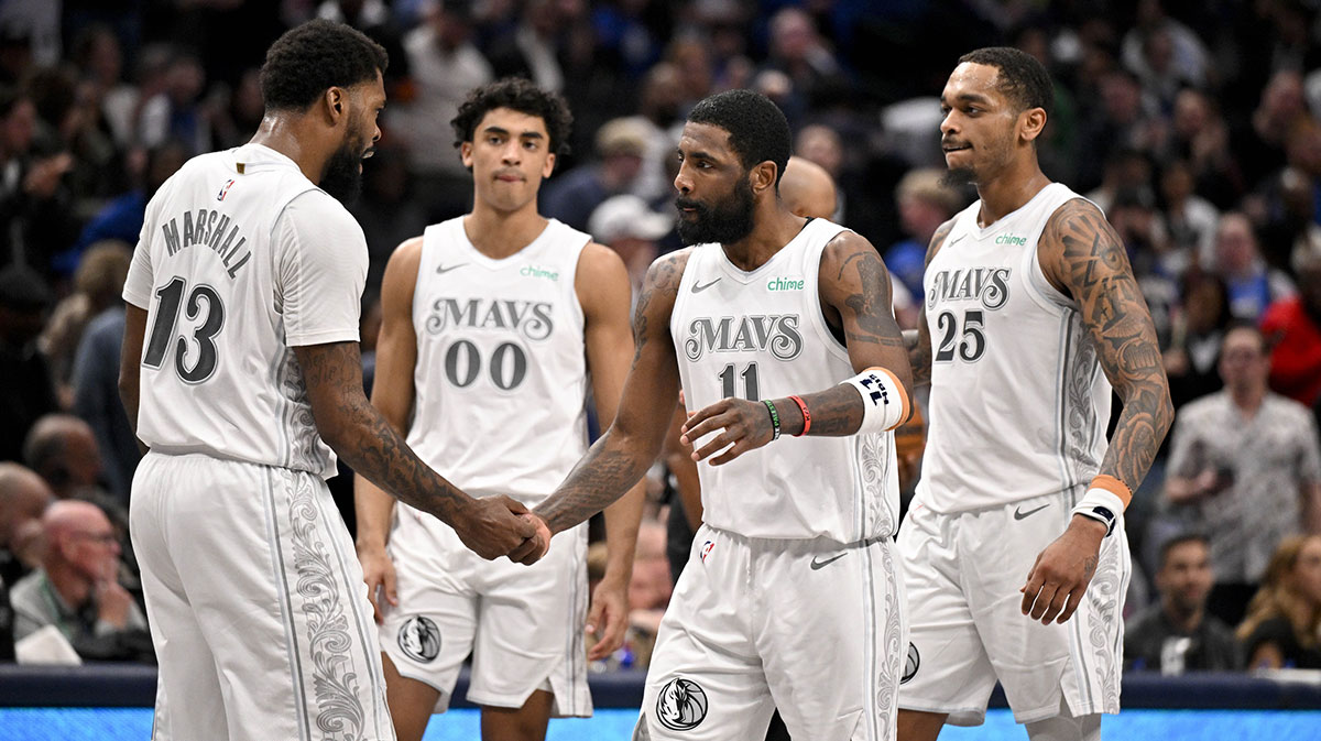 Mavericks guard Kyrie Irving (11) and forward Naji Marshall (13) and guard Max Christie (00) and forward P.J. Washington (25) celebrate