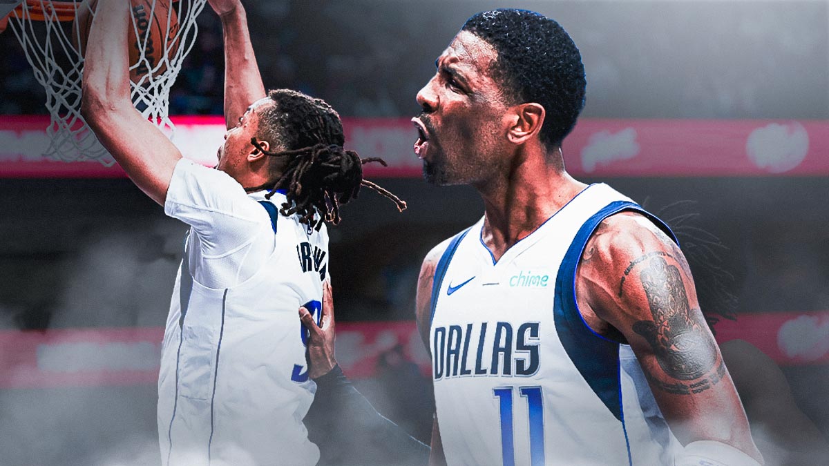 Moses Brown in a Mavericks uniform dunking a basketball. Mavericks Kyrie Irving looking at Brown.