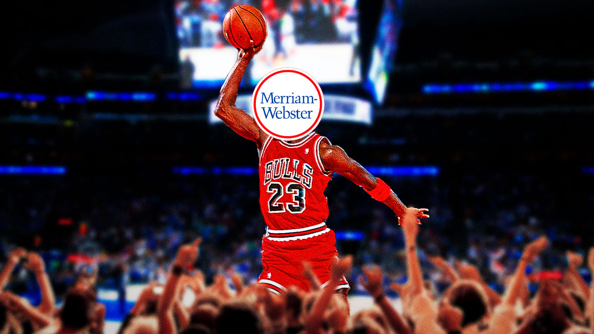 Michael Jordan in the dunk contest doing his signature free-throw line dunk. However, Jordan’s face has the Merriam Webster dictionary logo covering it