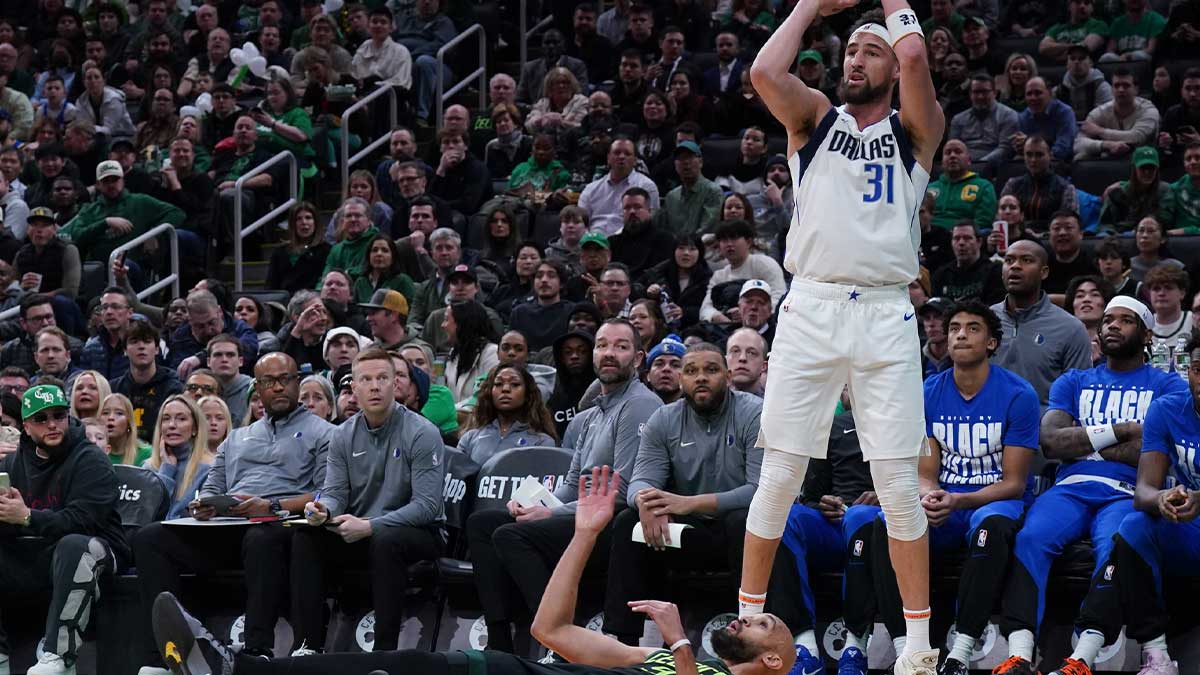 Dallas Mavericks Guard Klai Thompson (31) shoots for three points over the Boston Celtics Guard Derrick White (9) in the first quarter in the TD garden.