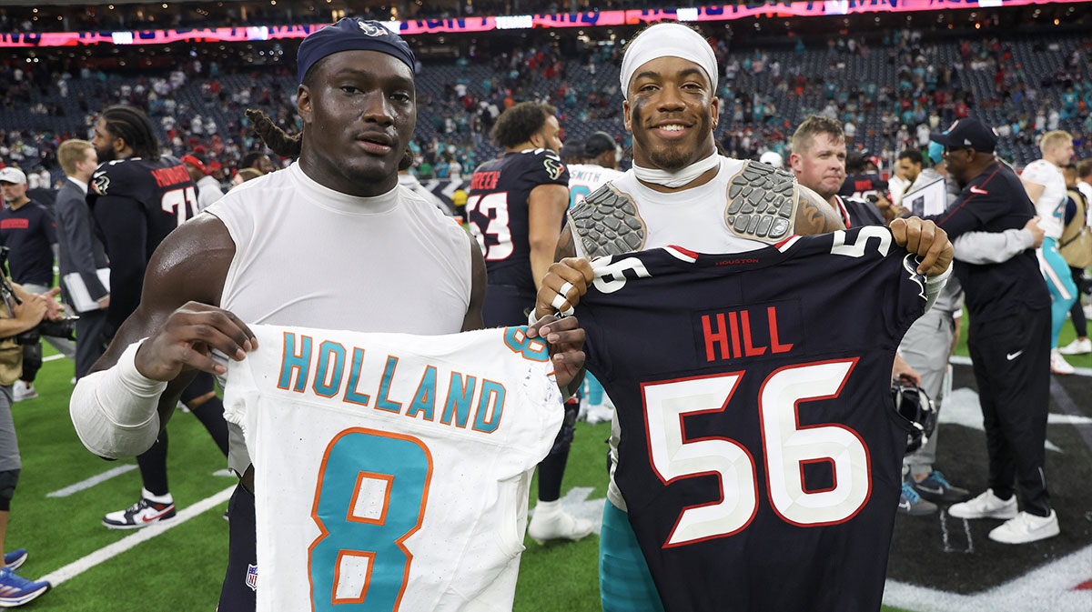 Houston Texans linebacker Jamal Hill (56) (left ) and Miami Dolphins safety Jevon Holland (8) exchange jerseys after a game at NRG Stadium.