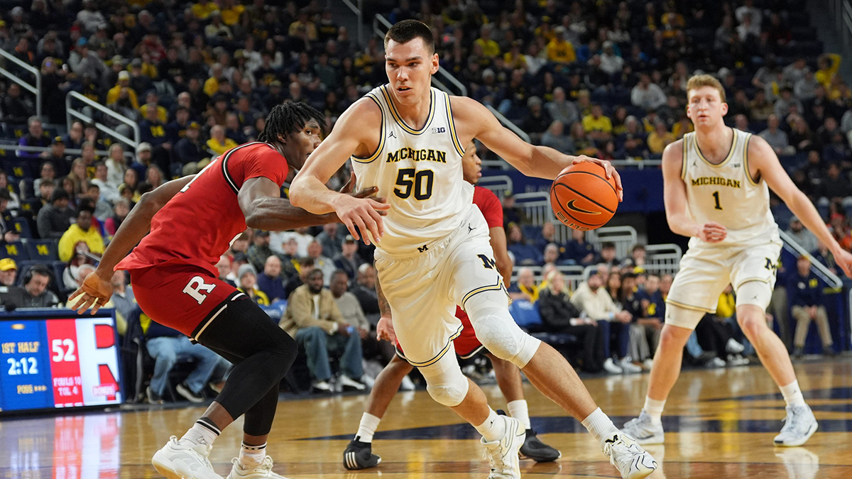 Michigan Wolverines center Vladislav Goldin (50) drives the lane against Rutgers Scarlet Knights defense during the first half of the NCAA basketball game at Crisler Arena in Ann Arbor, Mich., Thursday, February 27 2025.